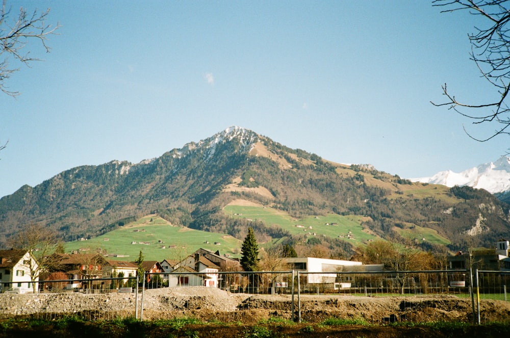 a view of a mountain with houses in the foreground