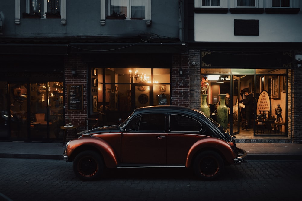 a car parked in front of a building at night