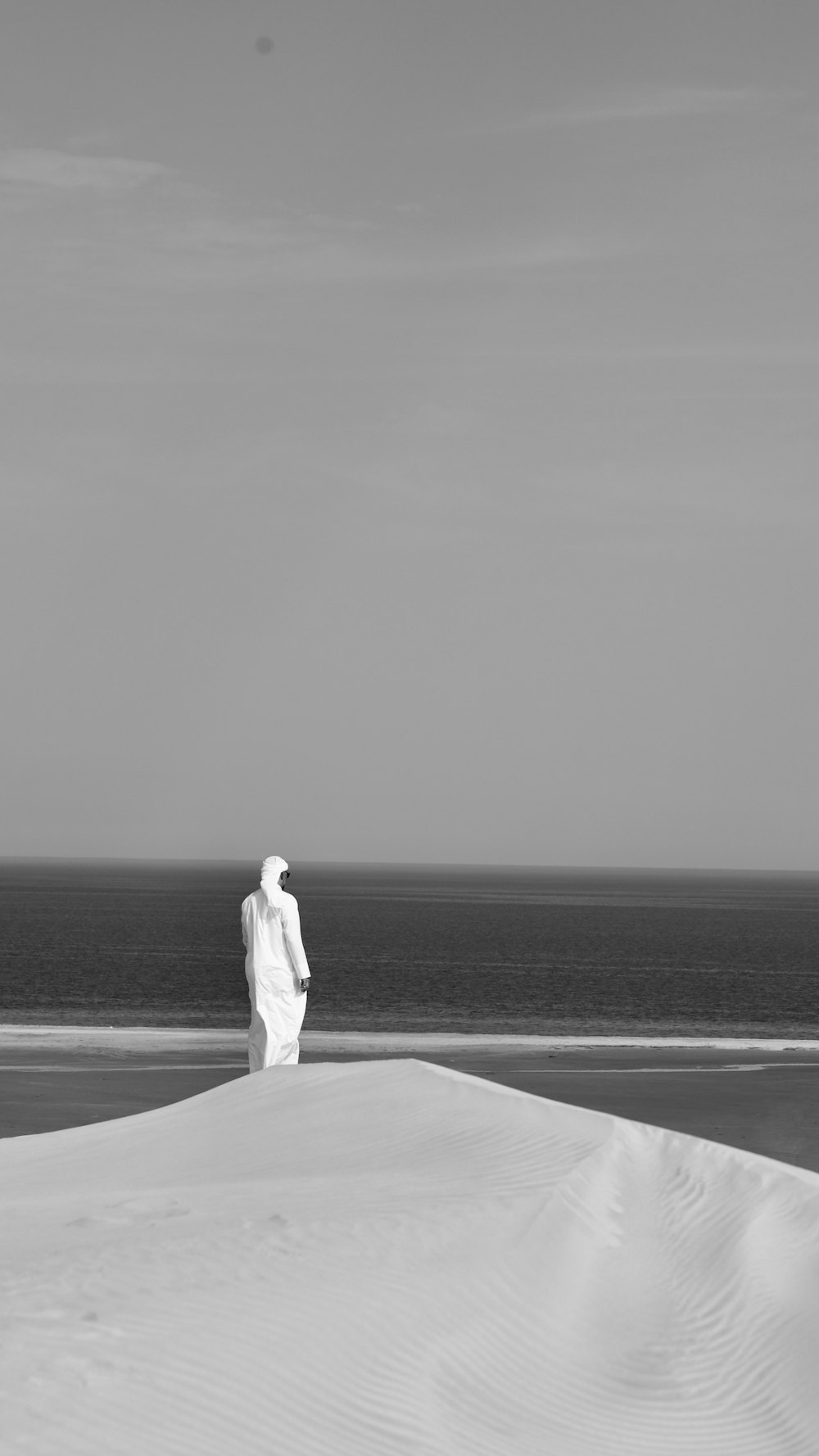 a man standing on top of a sandy beach