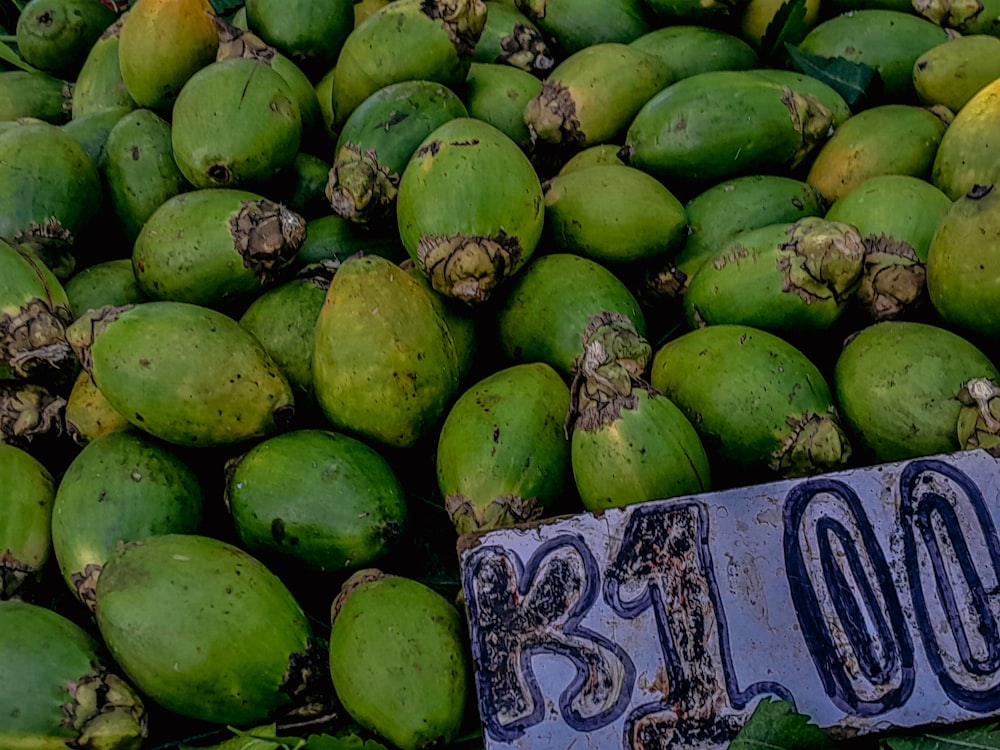 a pile of green coconuts sitting on top of each other