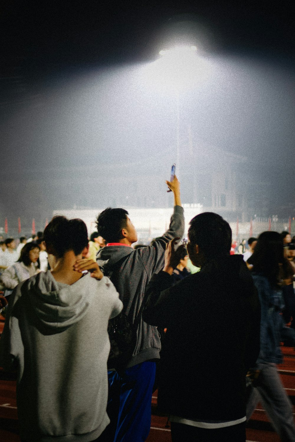 a group of people standing around a stadium