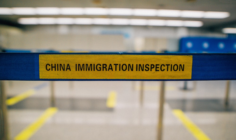 a yellow and blue sign that says china immigration inspection