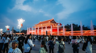 a crowd of people standing around a building
