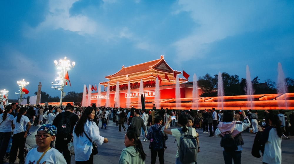 a crowd of people standing around a building