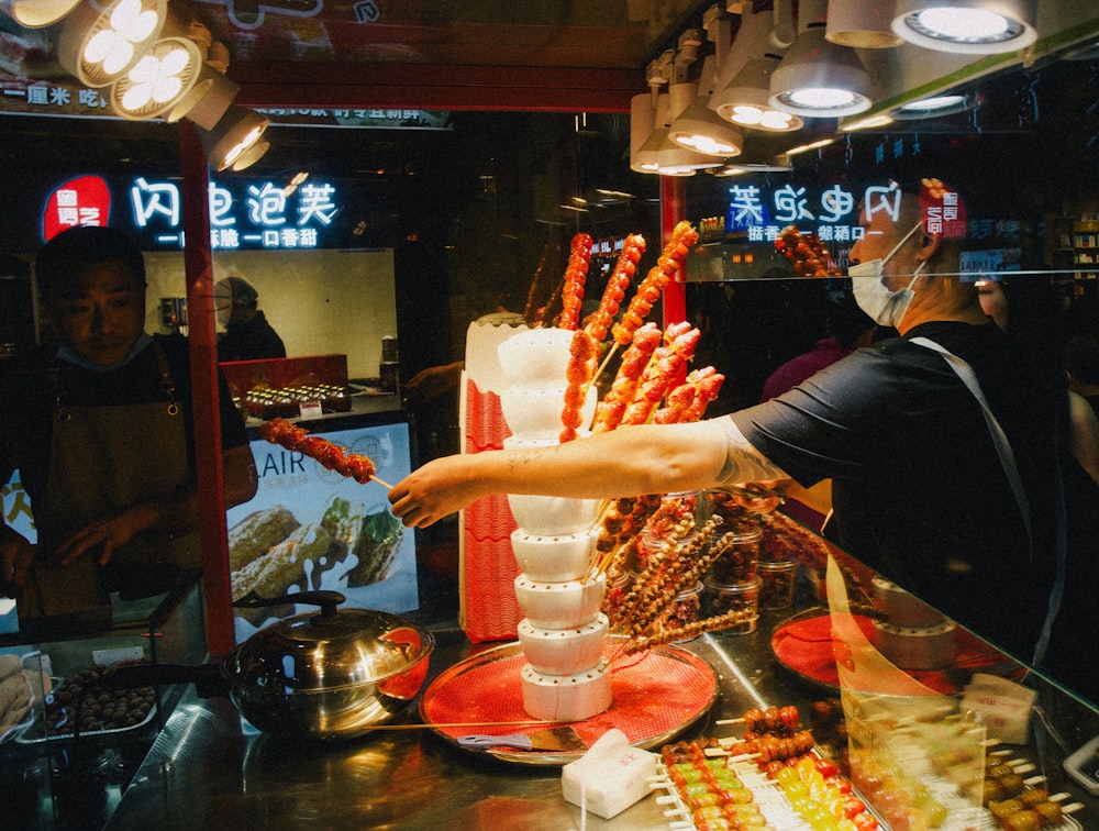 a person standing in front of a display of food