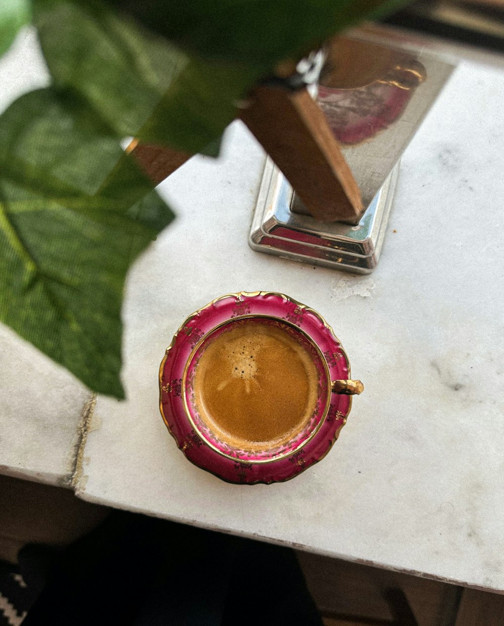 a cup of coffee sitting on top of a table