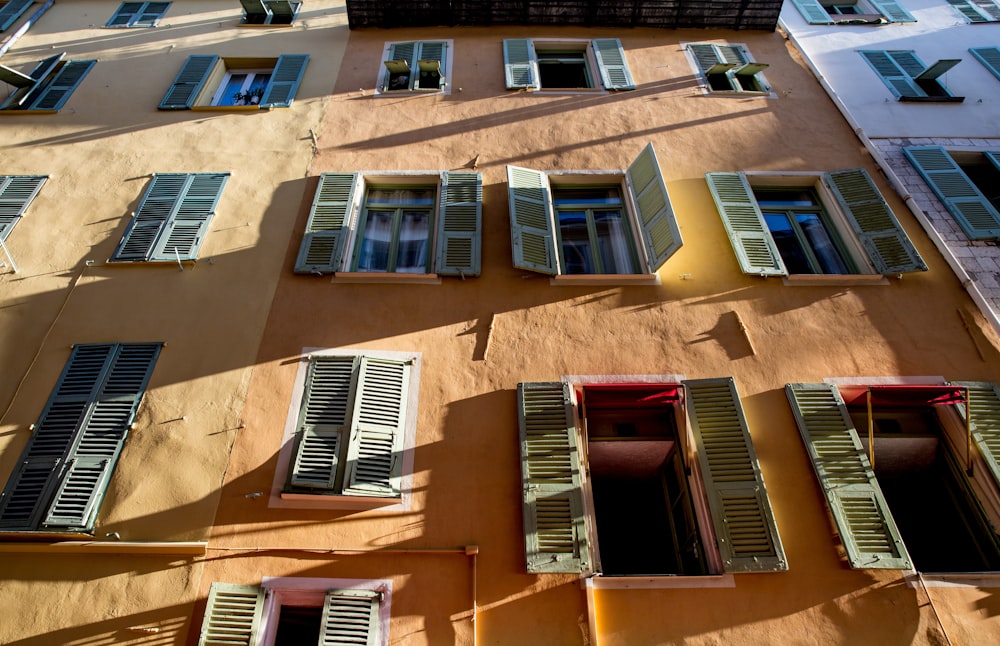 a tall building with lots of windows and shutters