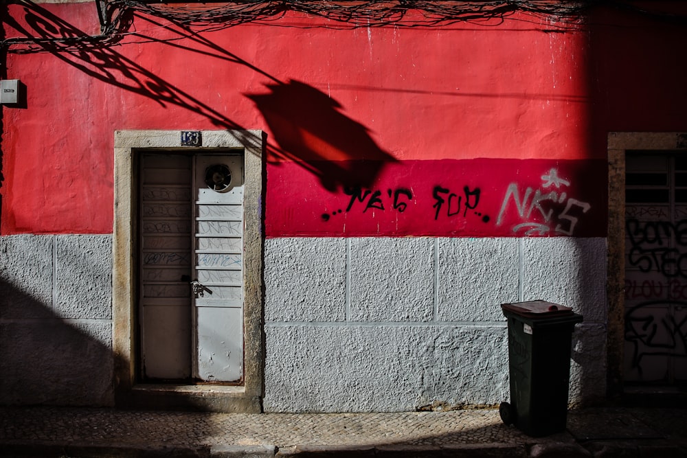 a red and white building with graffiti on it