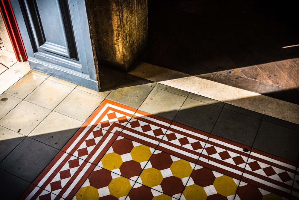 a tiled floor with a door in the background