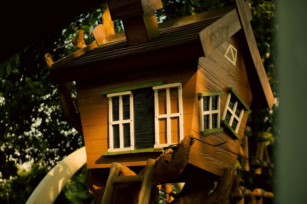 a bird house with a slide in the background