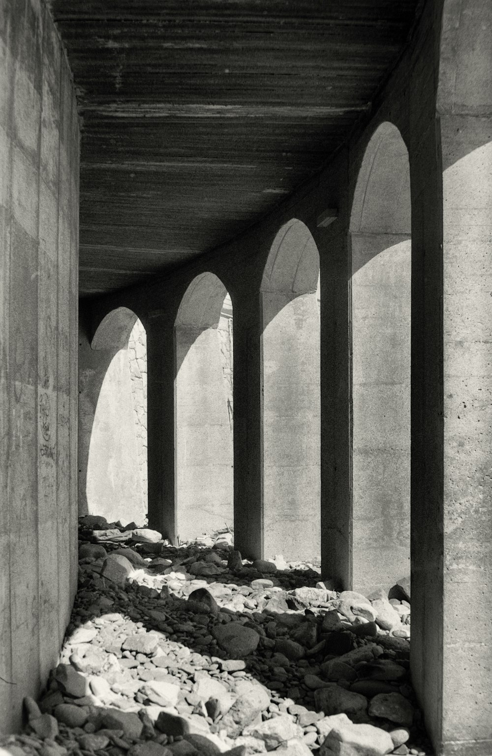a black and white photo of a row of arches