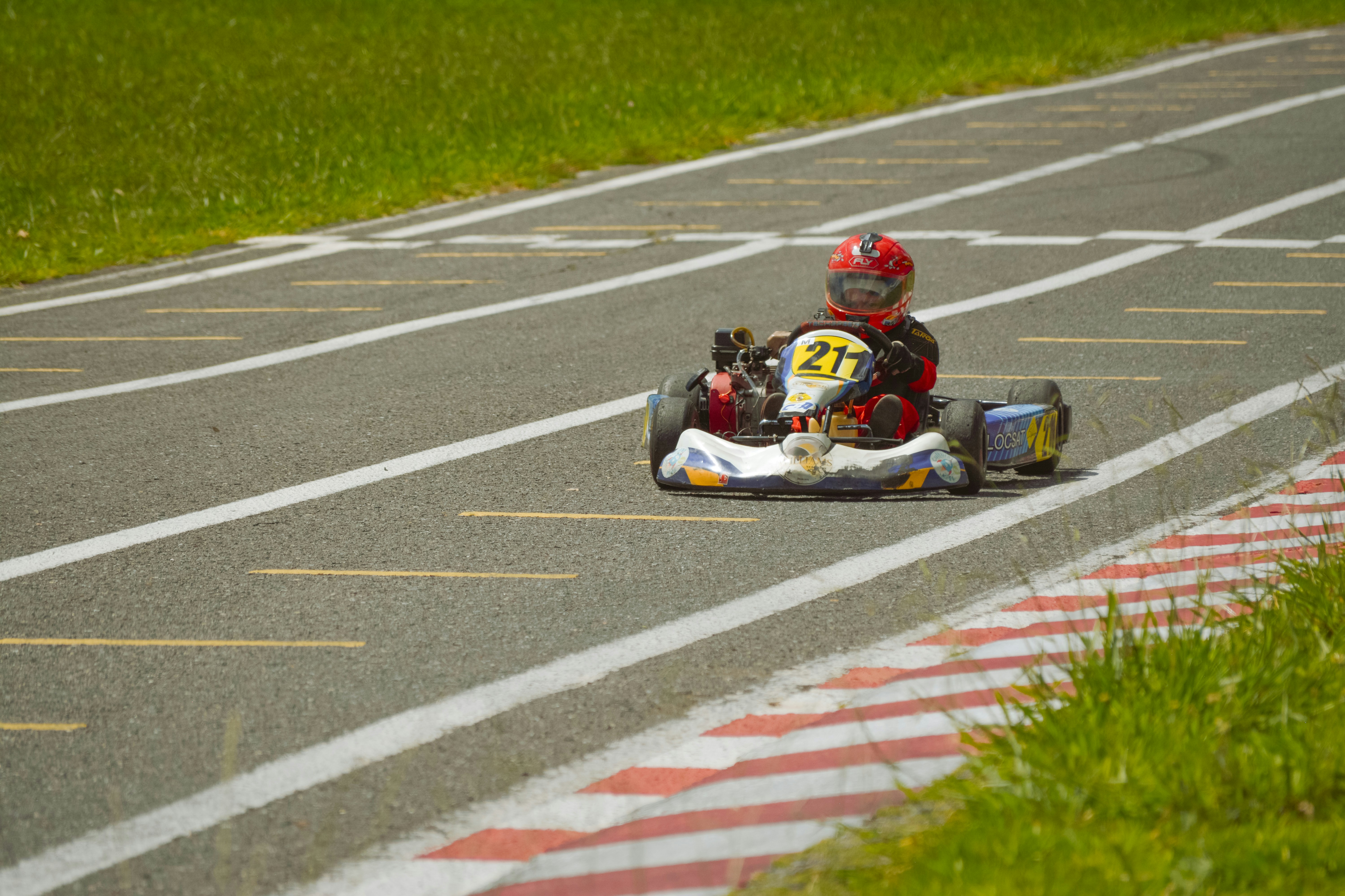 Person riding a go-kart on a race track