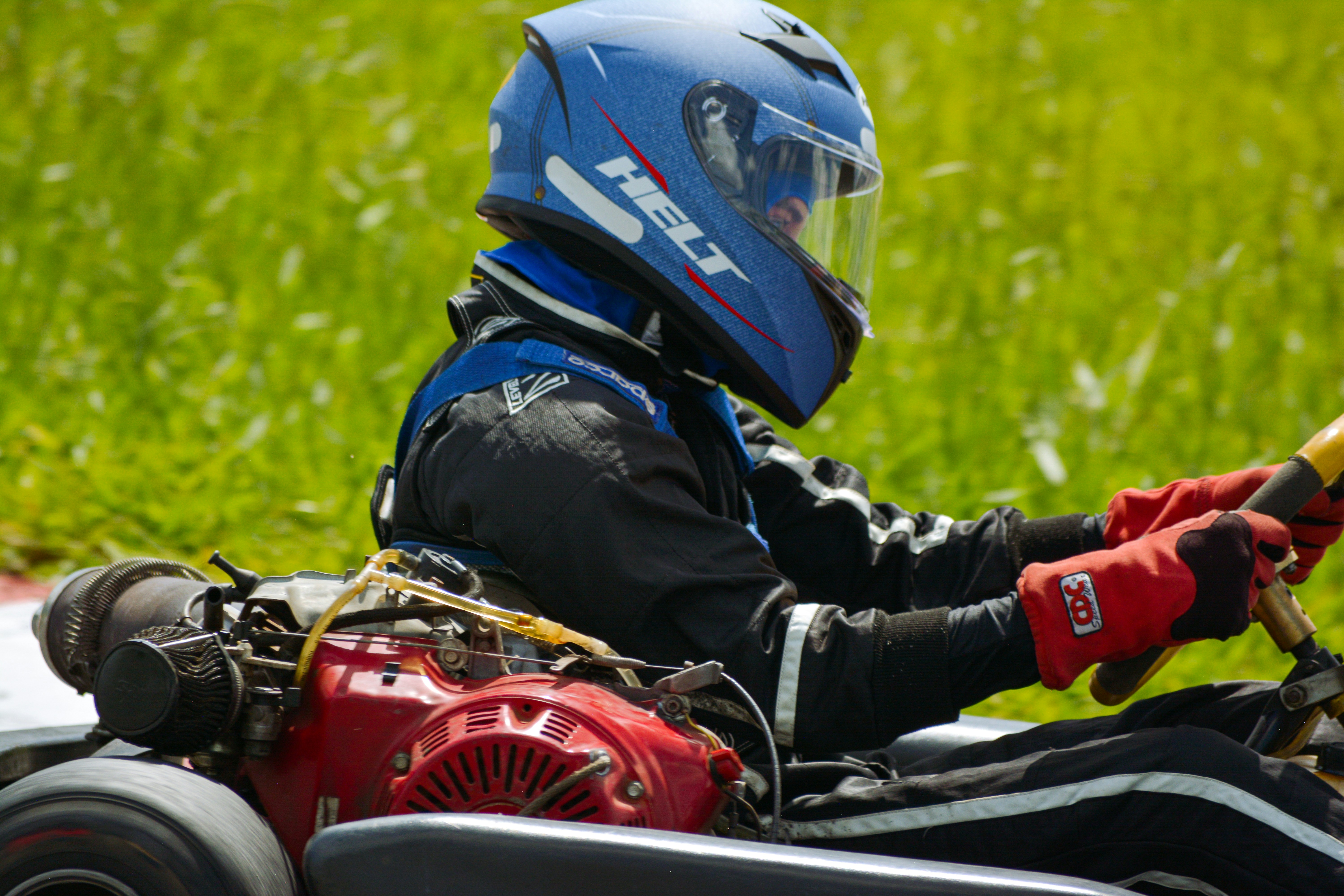 a person riding a go kart with a helmet on