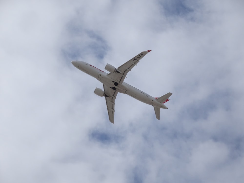 a large passenger jet flying through a cloudy sky