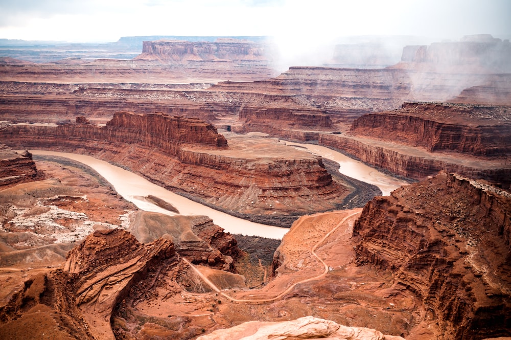 a river running through a canyon surrounded by mountains