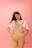a woman in overalls posing for a picture