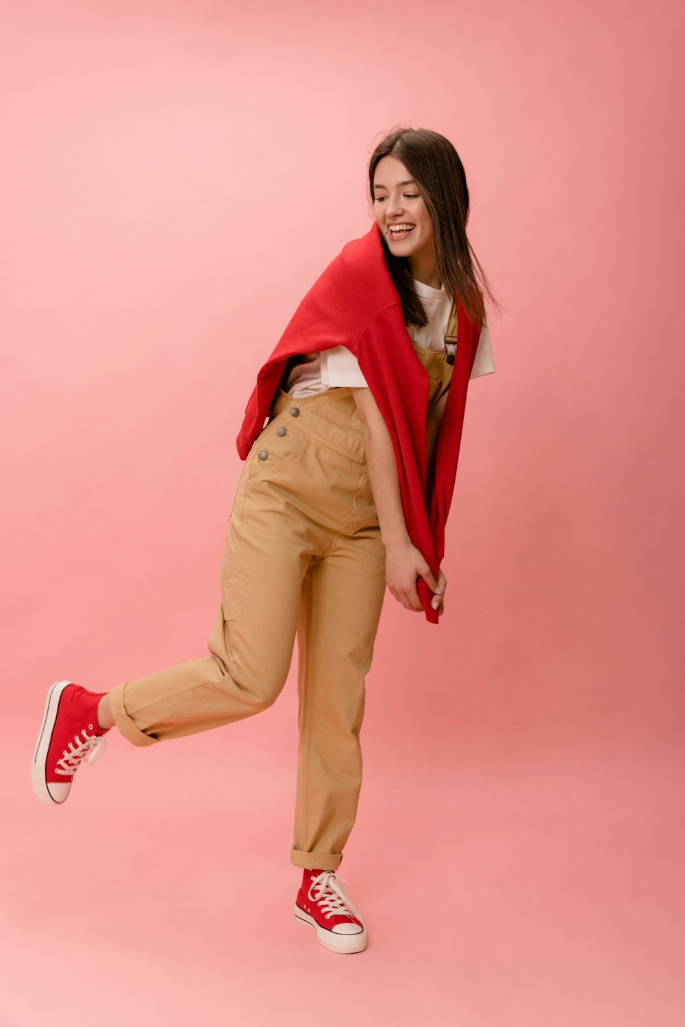 a woman in a red shawl is dancing