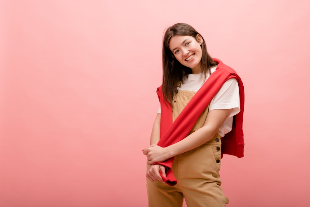 a woman in overalls and a red scarf