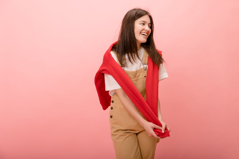 a woman in overalls and a red scarf