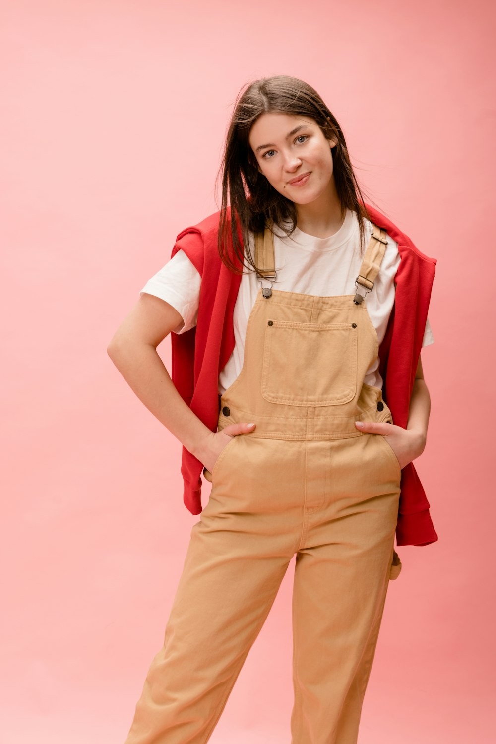 a woman in overalls posing for a picture