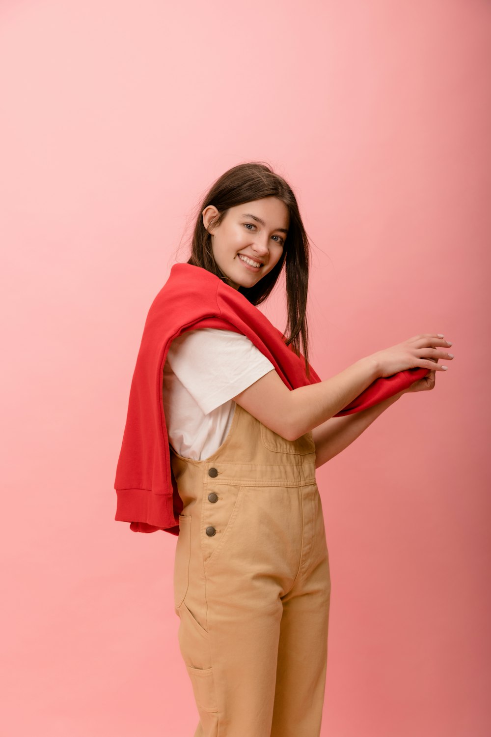 a woman in overalls and a red scarf