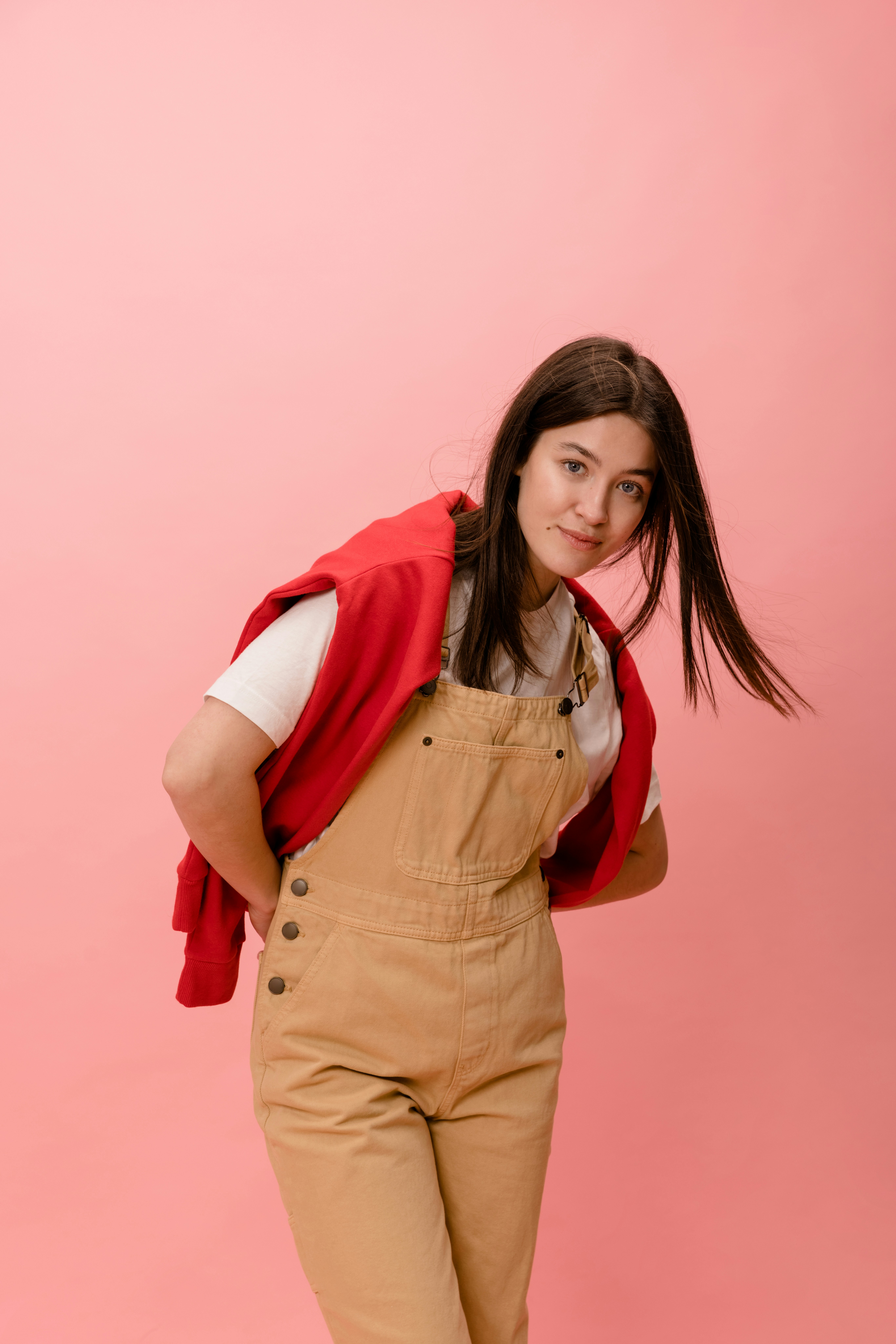 a woman in overalls posing for a picture