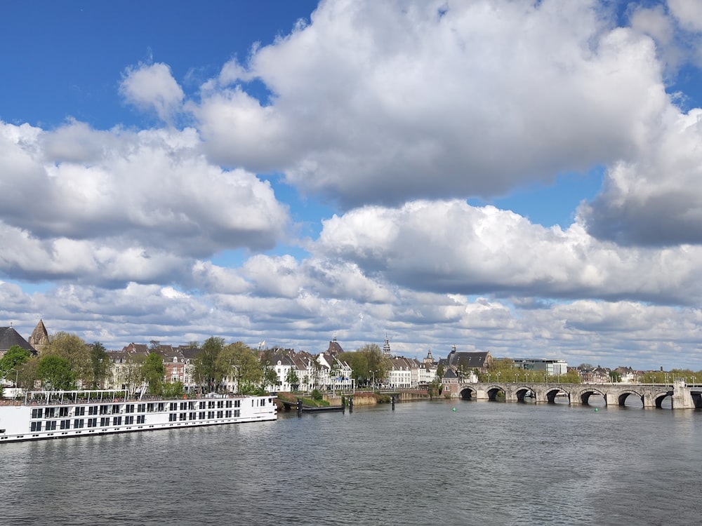 a river with a boat on it and a bridge in the background