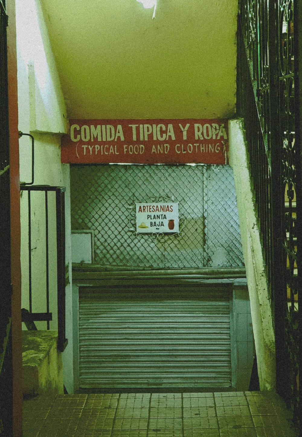 a closed door in a building with a sign above it