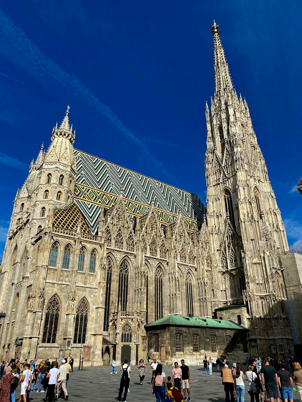 a group of people standing in front of a large cathedral