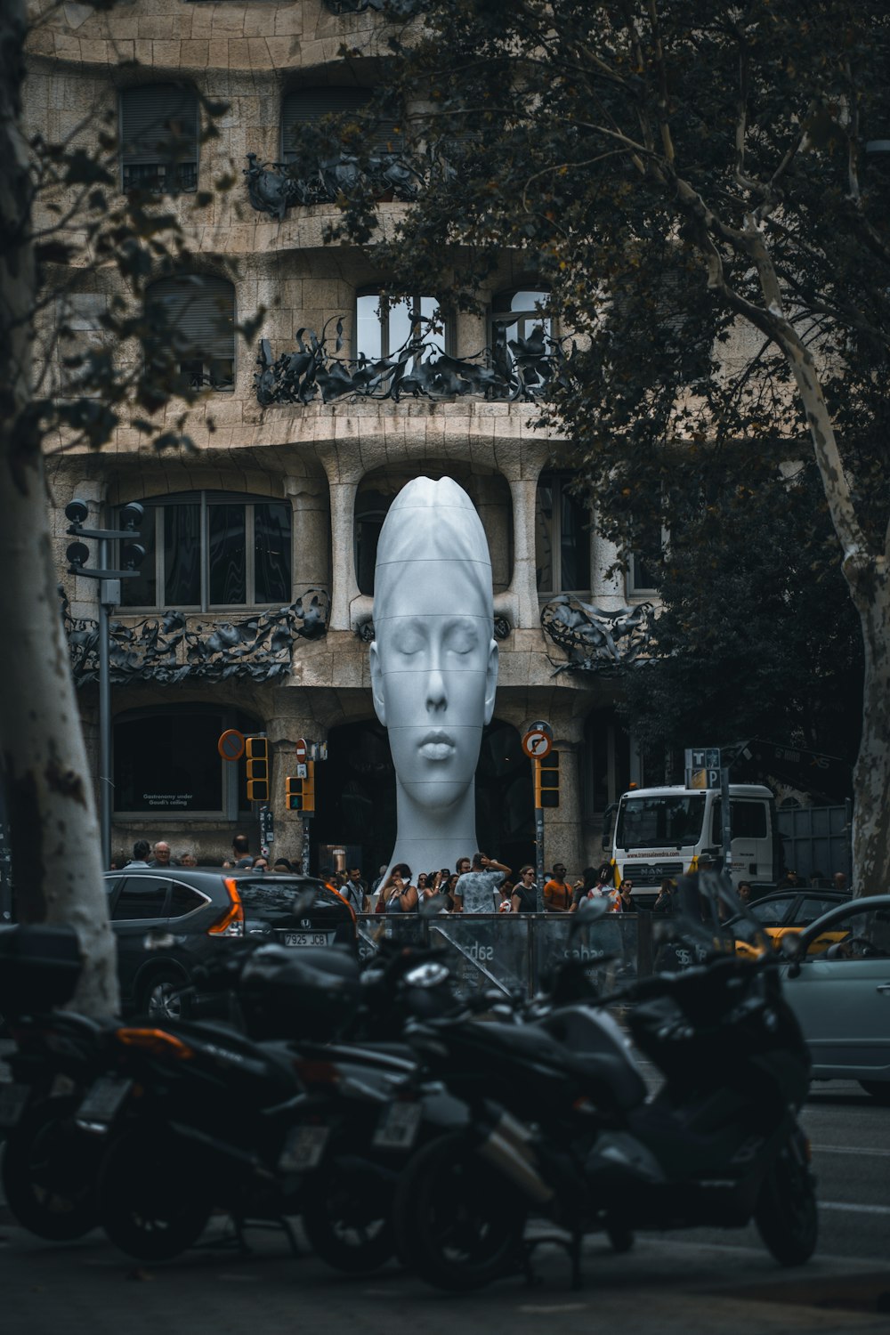 a statue of a woman's head in front of a building