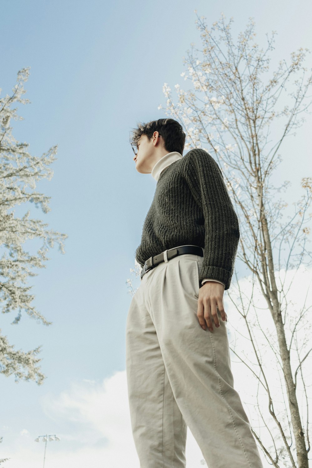 a man standing in front of a tree