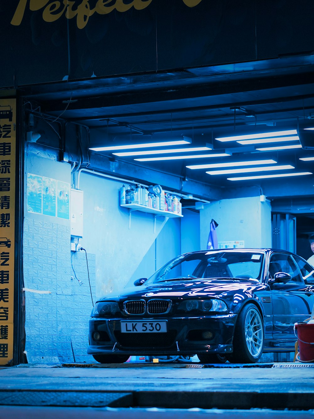 a car parked inside of a garage next to another car