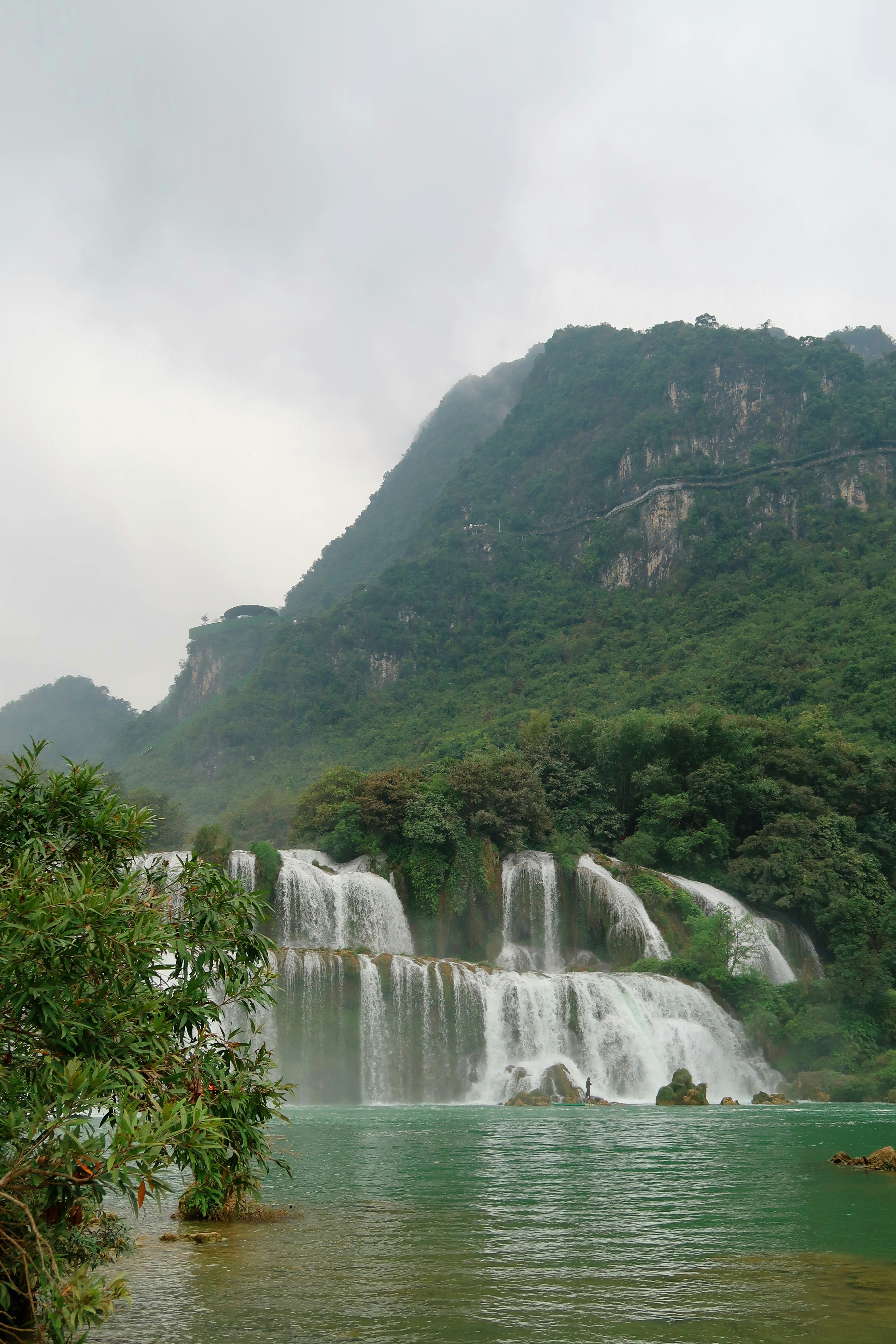 a large waterfall in the middle of a body of water