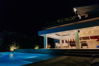 a house that has a pool in front of it