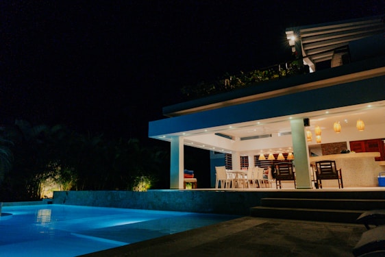 a house that has a pool in front of it