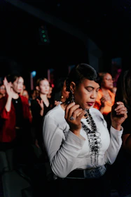 a woman standing in front of a crowd of people