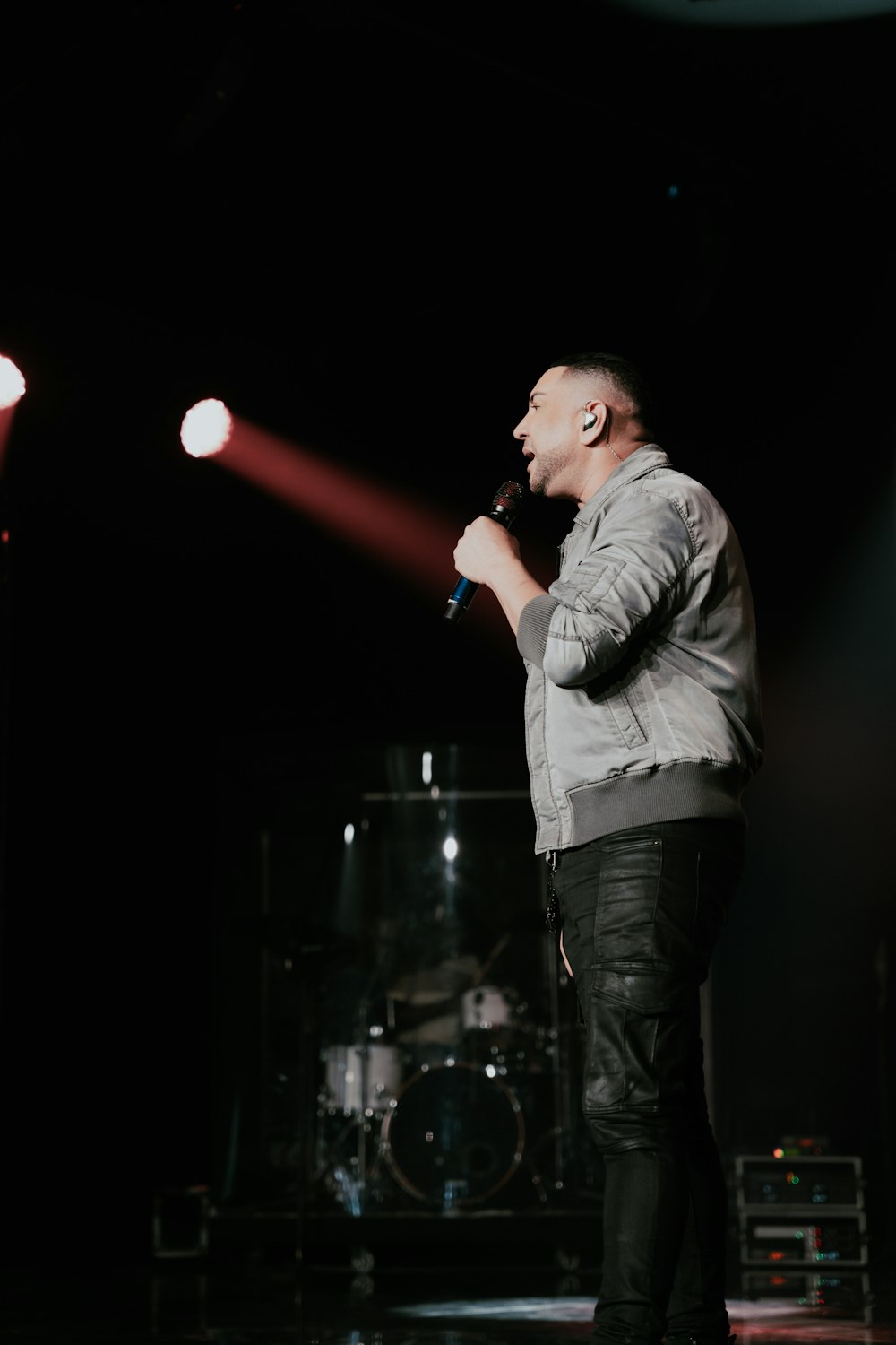 a man standing on a stage holding a microphone