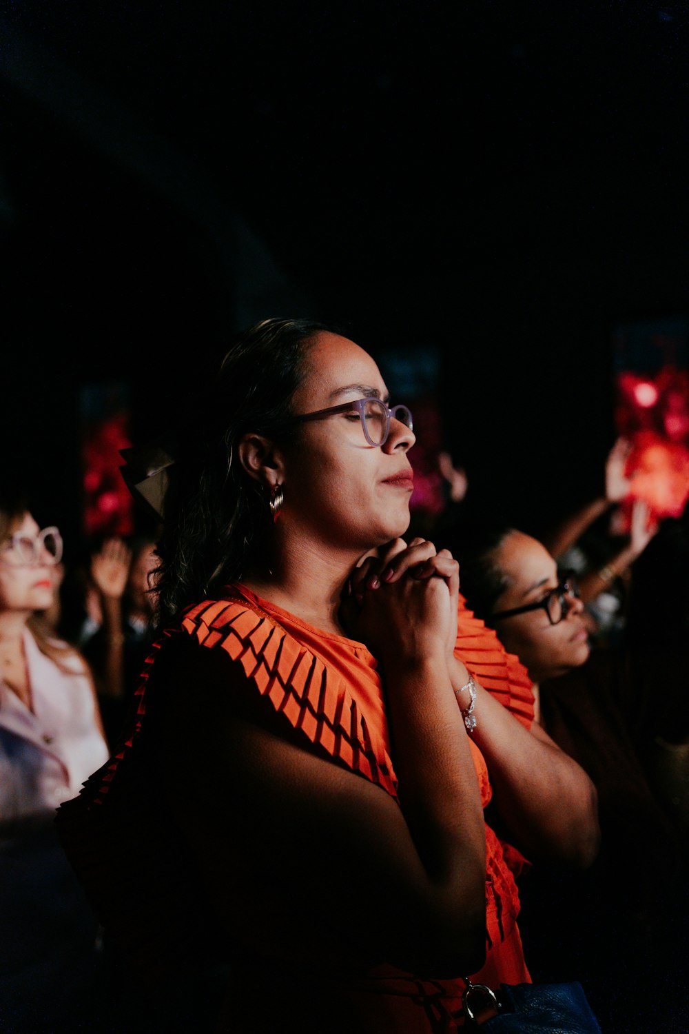 a woman standing in front of a crowd of people