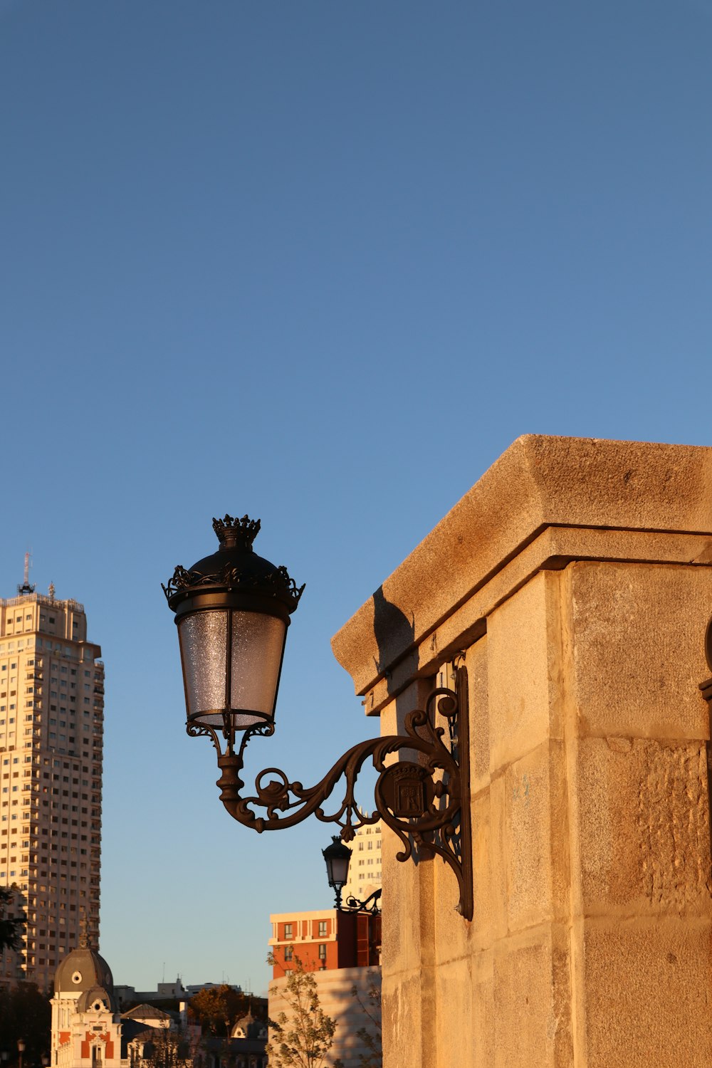 a lamp post with a building in the background