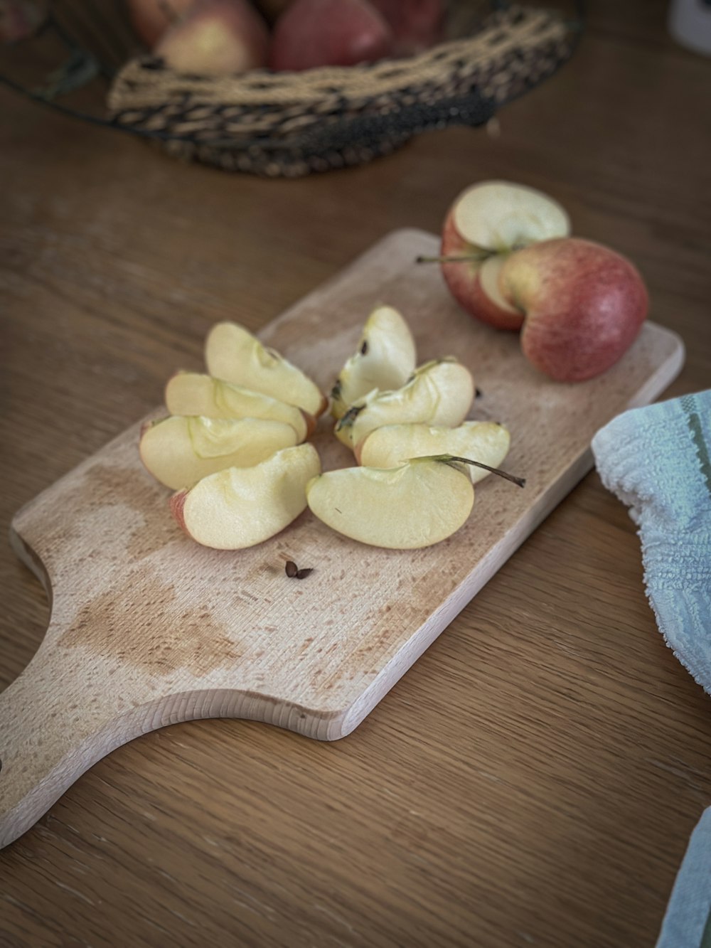 a wooden cutting board topped with sliced apples