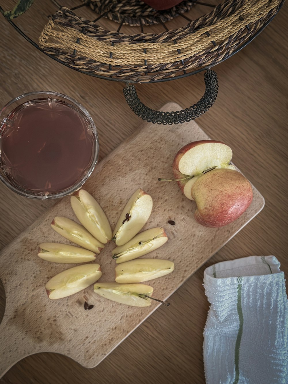 a wooden cutting board topped with sliced apples