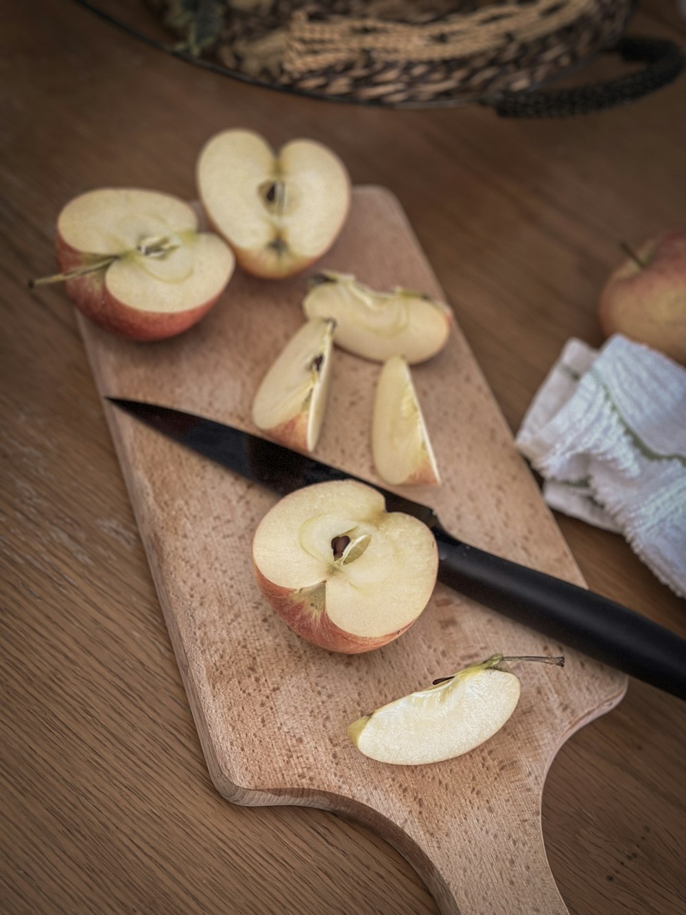 a wooden cutting board topped with sliced apples