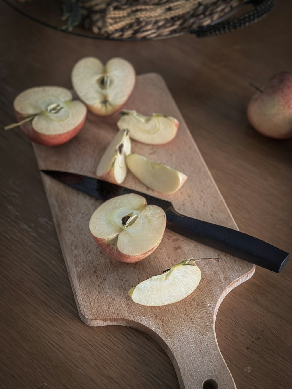 a wooden cutting board topped with sliced apples