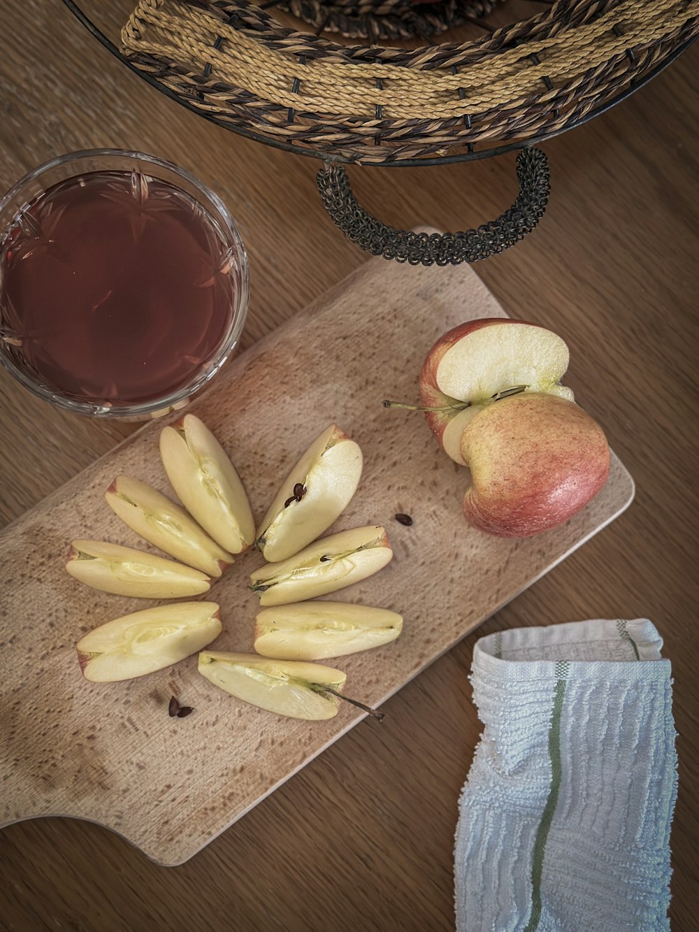 a wooden cutting board topped with sliced apples