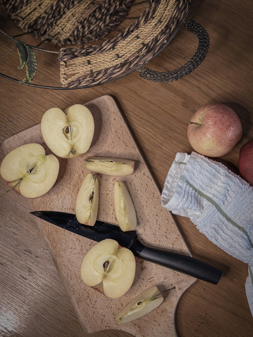 a cutting board topped with sliced apples next to a knife