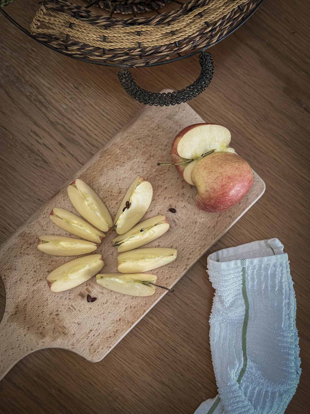 a wooden cutting board topped with sliced apples