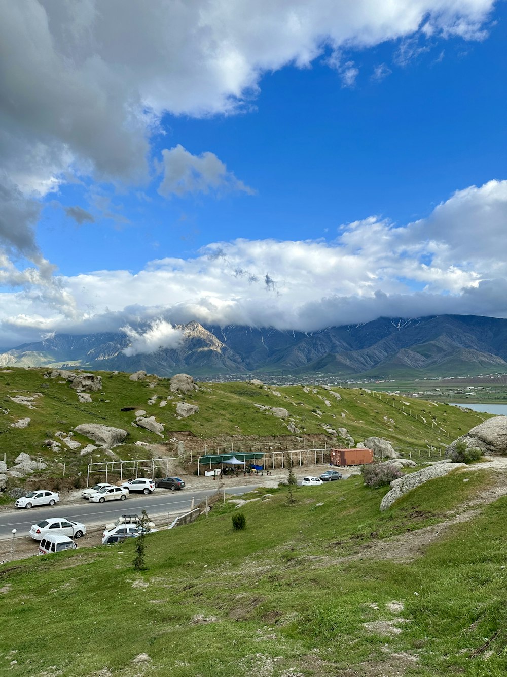 a view of a mountain with cars parked on the side of it