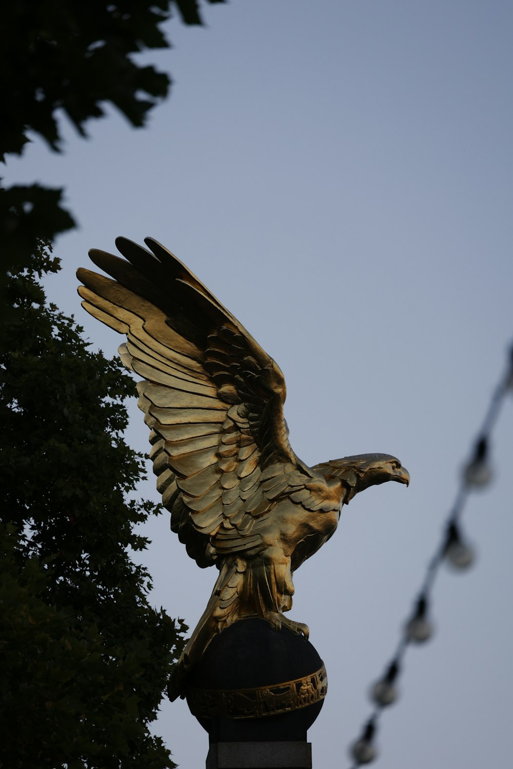 a statue of an eagle on top of a lamp post