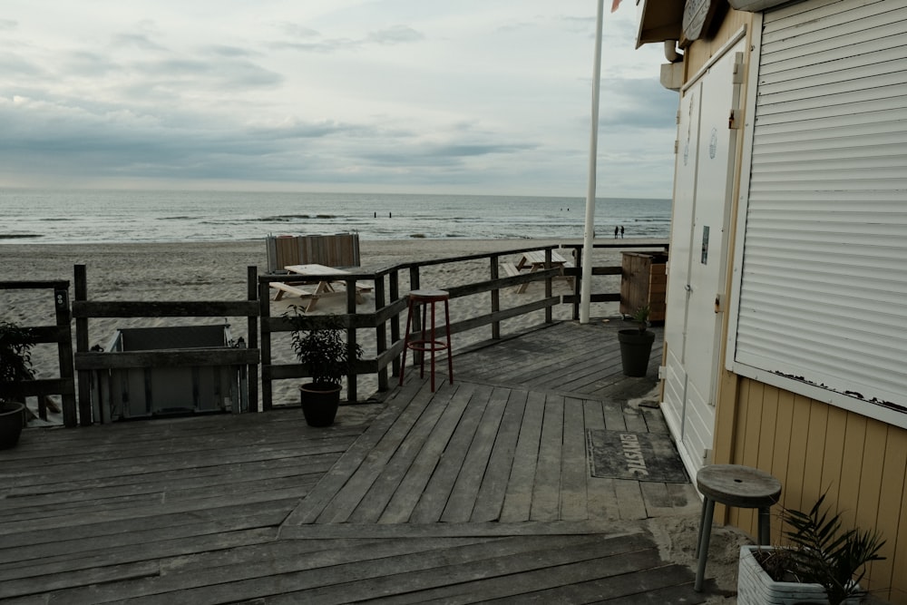 a wooden deck next to a building on a beach