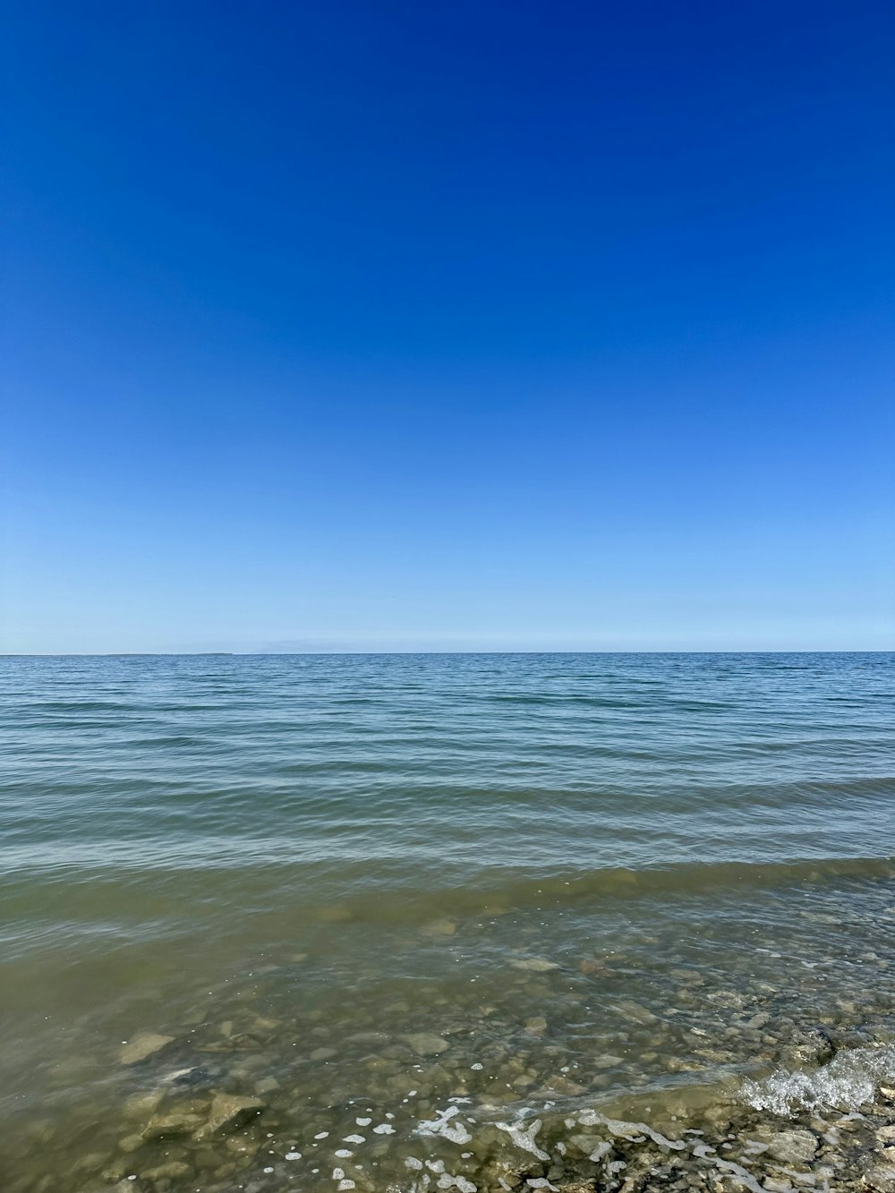 a view of the ocean from the shore of a beach